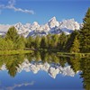 Snow-capped Teton Mountains in spring, reflected in beaver pond on Snake River. Grand Teton National Park, Wyoming. USA. June 2005. 